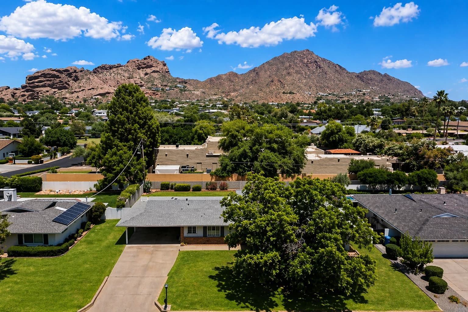 Ranch-style residence on a mature lot with Camelback Mountain in the near distance.